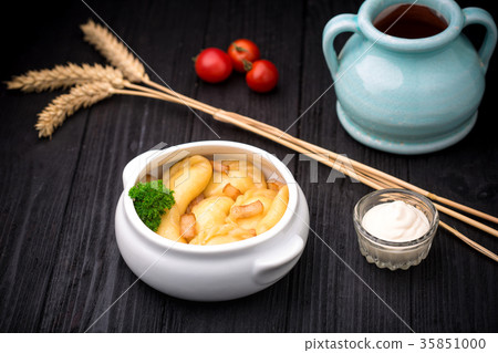 Dumplings with potatoes and cracknel on black wooden background 35851000