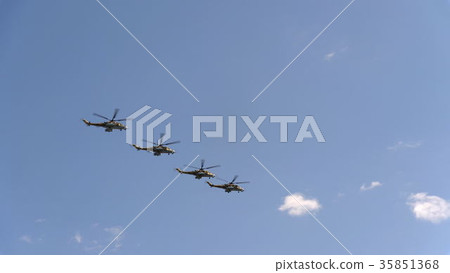 Combat helicopters Mi-24 fly in blue sky 35851368