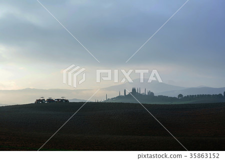Farmer in tractor preparing land with seedbed cultivator 35863152