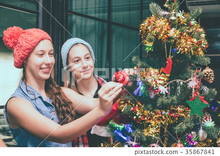 Beautiful girls with presents at Christmas party. 35867841