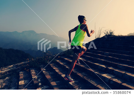 woman trail runner running on the top of mountain 35868074