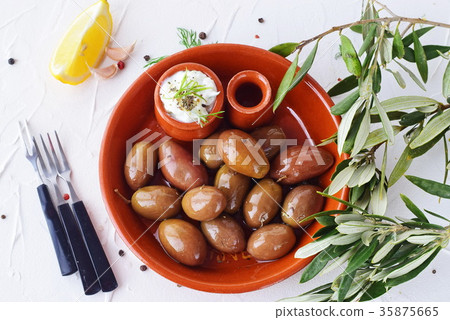 Olives in a traditional brown ceramic bowl 35875665