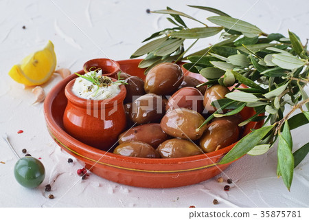 Olives in a traditional brown ceramic bowl Olives in a traditional brown ceramic bowl 35875781