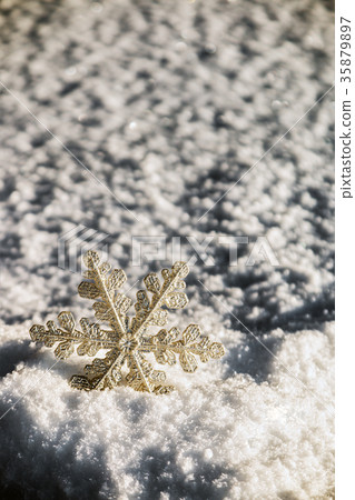 decorative snowflake sticking out of the snow  35879897