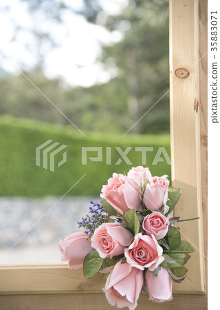 Artificial flower a natural background blurred. Artificial flower a natural background blurred. 35883071