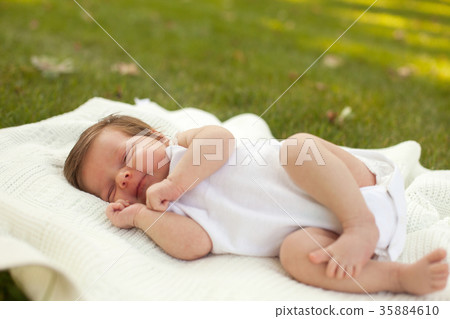 Baby sleeping on the grass Baby sleeping on the grass 35884610