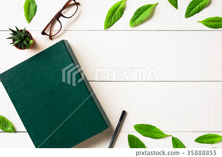 Flat lay book glasses and pen on a white wood Flat lay book glasses and pen on a white wood 35888855