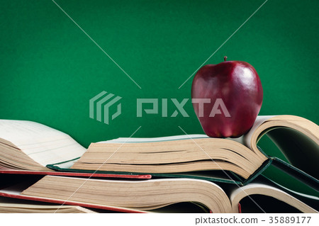 Books Pencil and apple on a white wooden table Books Pencil and apple on a white wooden table 35889177