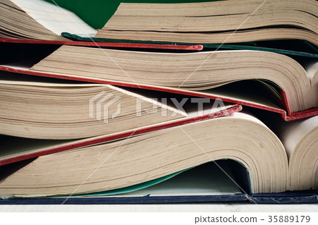 old books open on table at the library 35889179