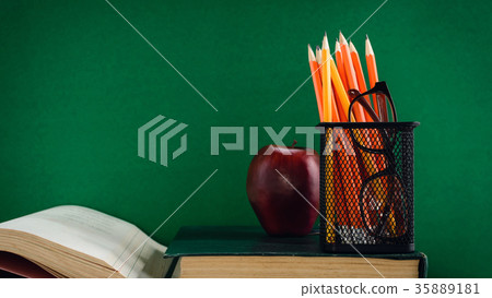 Books Pencil and apple on a white wooden table Books Pencil and apple on a white wooden table 35889181