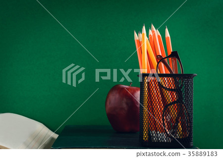 Books Pencil and apple on a white wooden table Books Pencil and apple on a white wooden table 35889183