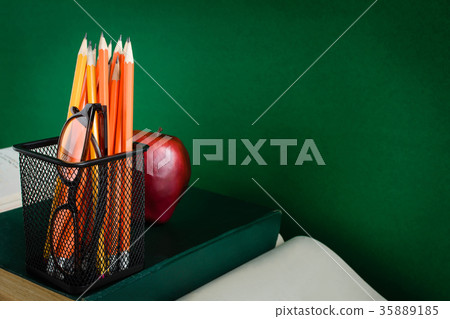 Books Pencil and apple on a white wooden table Books Pencil and apple on a white wooden table 35889185