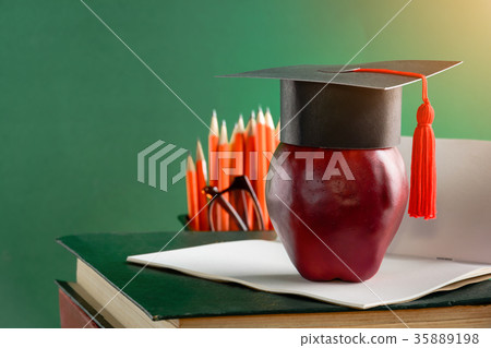 graduate cap and apple on old book graduate cap and apple on old book 35889198