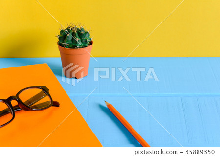 Books Pencil and glasses on a blue wooden table Books Pencil and glasses on a blue wooden table 35889350