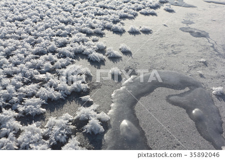 Rime on the ice of the freezing river 35892046