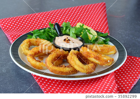 Calamari rings fried with spicy sauce 35892299
