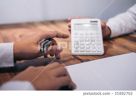 Man sign a home insurance policy on home loans, Agent agent hold Man sign a home insurance policy on home loans, Agent agent hold 35892702