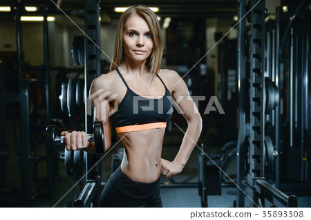 Sexy athletic young girl training arms in gym 35893308
