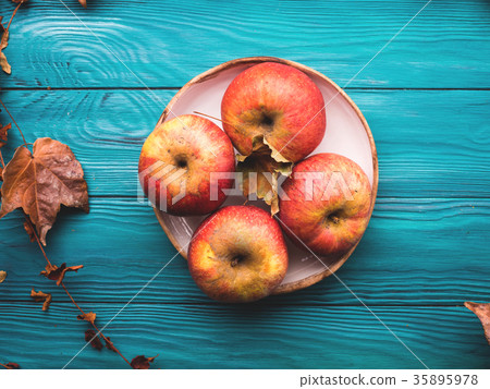 Red apples on Green autumn background Red apples on Green autumn background 35895978