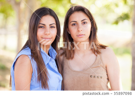 Two Beautiful Ethnic Twin Sisters Portrait Outdoors. Two Beautiful Ethnic Twin Sisters Portrait Outdoors. 35897098