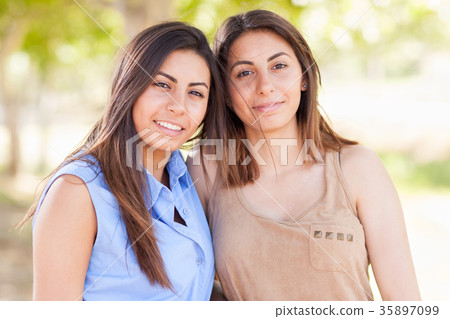 Two Beautiful Ethnic Twin Sisters Portrait Outdoors. Two Beautiful Ethnic Twin Sisters Portrait Outdoors. 35897099