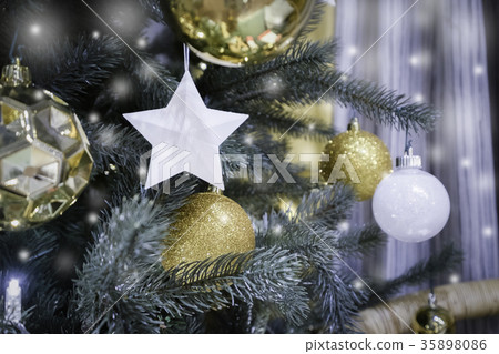 Decorated Christmas tree with star and gold ball 35898086