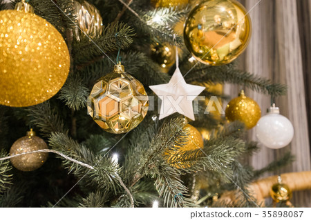Decorated Christmas tree with star and gold ball 35898087