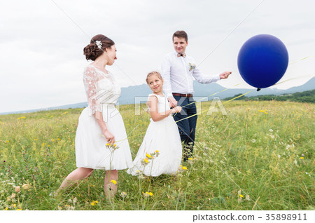 A young couple and their daughter in wedding A young couple and their daughter in wedding 35898911
