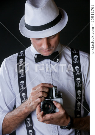 Young stylish man with photo camera Young stylish man with photo camera 35911765