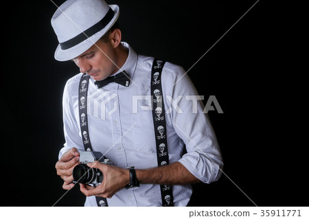 Young stylish man with photo camera Young stylish man with photo camera 35911771