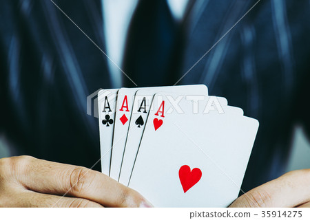 Businessman's hand holding playing cards Close-up studio shot 35914275