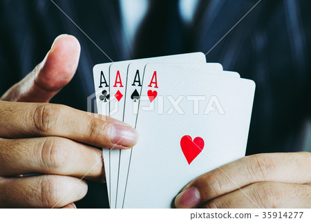 Businessman's hand holding playing cards Close-up studio shot Businessman's hand holding playing cards Close-up studio shot 35914277