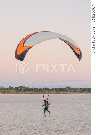 young woman parachuting down to the ground  35920304