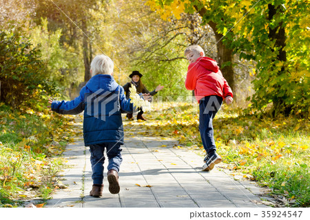Boys running towards her mother. Autumn Park Boys running towards her mother. Autumn Park 35924547