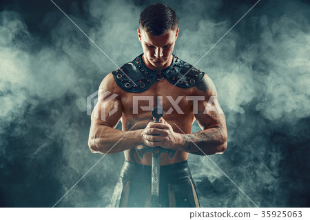 Severe barbarian in leather costume with sword Severe barbarian in leather costume with sword 35925063