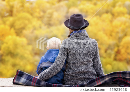 Mother and son are sitting on a high ground Mother and son are sitting on a high ground 35925638
