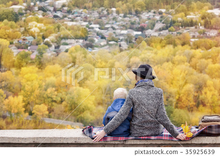 Mother and son are looking at city from a height Mother and son are looking at city from a height 35925639