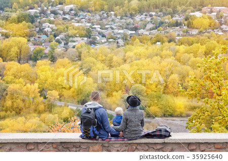 Parents and son looking at the city from a height Parents and son looking at the city from a height 35925640