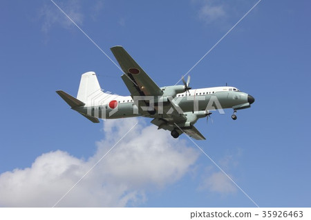Japan Self-Defense Forces domestic transport aircraft YS-11M flying in the blue sky with beautiful clouds floating Japan Self-Defense Forces domestic transport aircraft YS-11M flying in the blue sky with beautiful clouds floating 35926463
