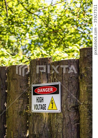 High voltage sign on a wooden fence High voltage sign on a wooden fence 35927311