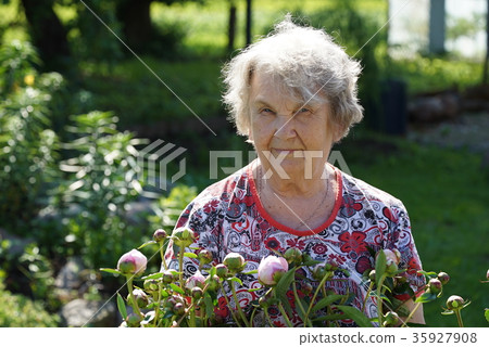 Portrait of old smiling woman in the park 35927908