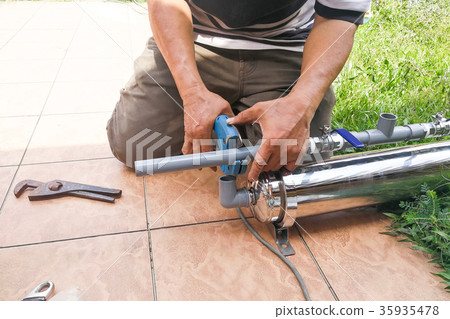 Series of plumber fixing up outdoor water filter  35935478