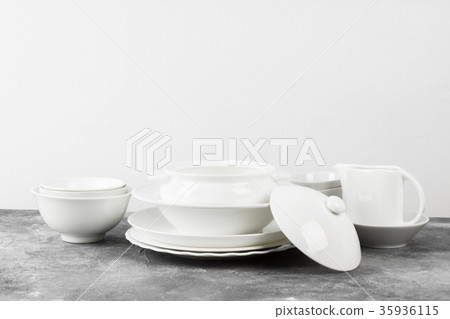 Clean white tableware on a gray background Clean white tableware on a gray background 35936115