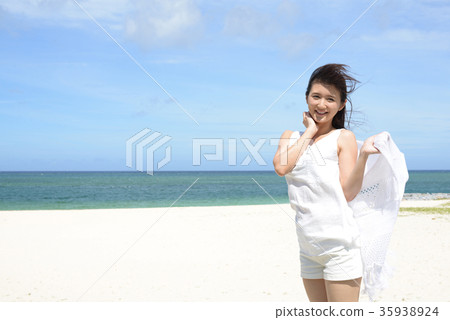 A woman relaxing on the beautiful beach of Tropical Okinawa A woman relaxing on the beautiful beach of Tropical Okinawa 35938924