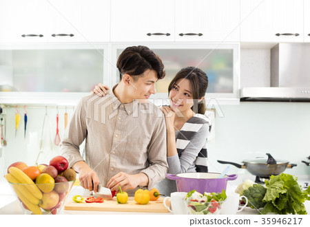 happy asian Couple cooking in the kitchen happy asian Couple cooking in the kitchen 35946217