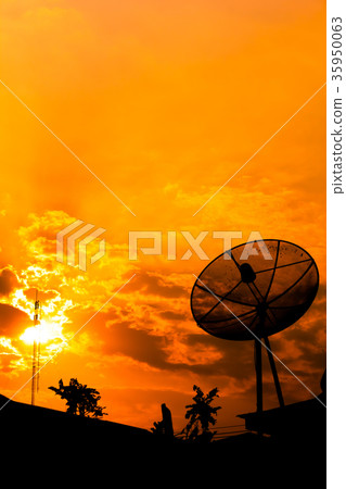 Satellite dish with orange sky Satellite dish with orange sky 35950063