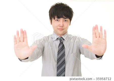 A businessman who makes a stop gesture A businessman who makes a stop gesture 35958712