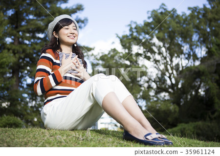 Woman enjoying reading in the park Woman enjoying reading in the park 35961124