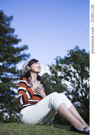 Woman enjoying reading in the park Woman enjoying reading in the park 35961126