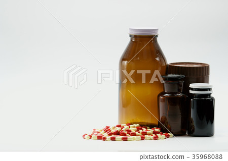 Antibiotic capsule pills and amber bottles  35968088